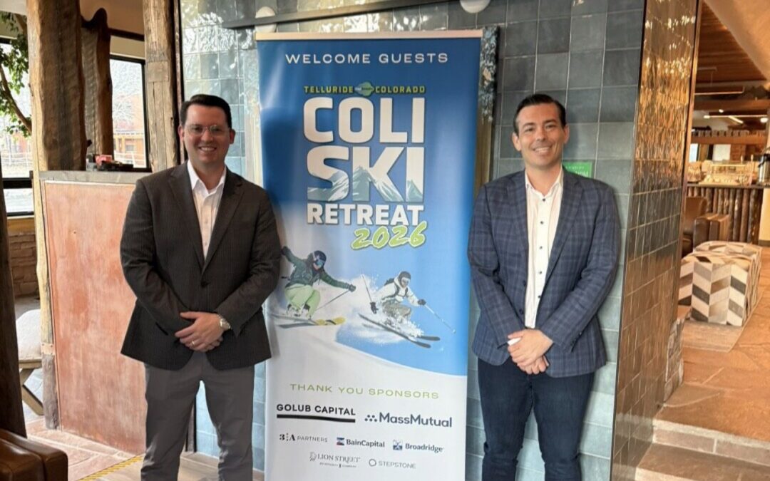 Alex Jones of Guardian Tax Consultants and Jake Valente standing in front of the COLI Ski Retreat 2026 welcome banner at Chipeta Lodge in Ridgway, Colorado, with sponsor logos including MassMutual, Golub Capital, BainCapital, Broadridge, Lion Street, and StepStone visible.